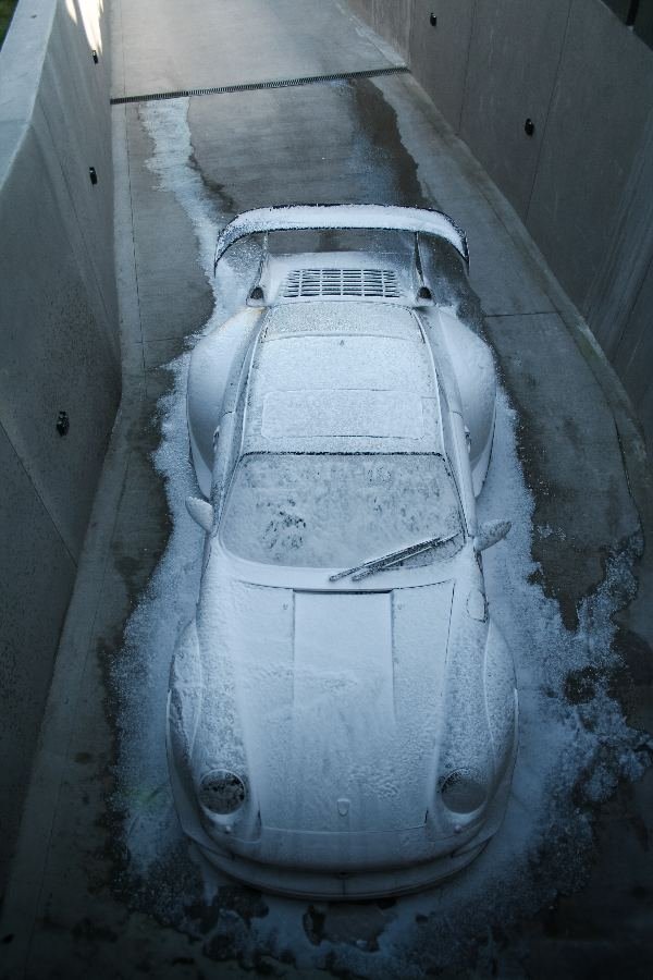 RWB Porsche 993 dusted with snow on a concrete ramp
