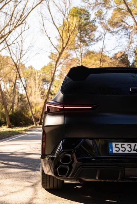 Matte black BMW XM rear with stacked quad exhaust